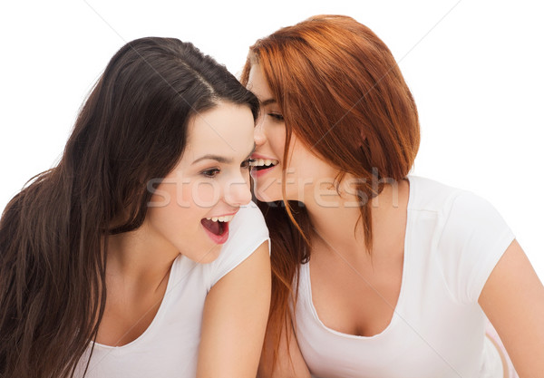 Deux souriant filles chuchotement potins amitié Photo stock © dolgachov