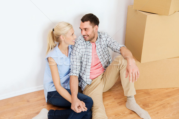 couple with cardboard boxes moving to new home Stock photo © dolgachov