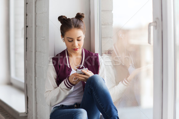teenage girl with smartphone and earphones Stock photo © dolgachov