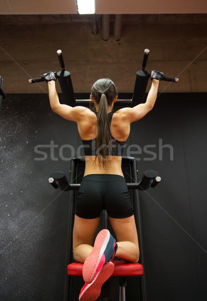 woman exercising and doing pull-ups in gym Stock photo © dolgachov