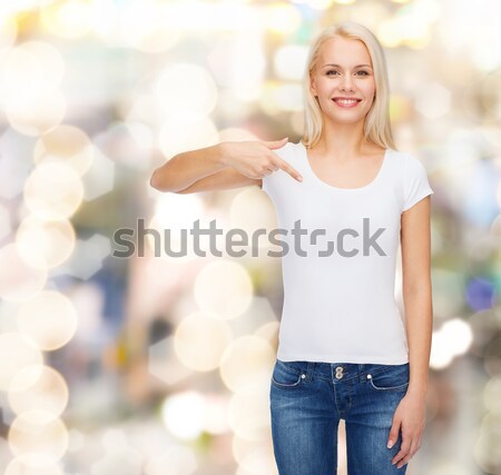 smiling woman in white t-shirt pointing to you Stock photo © dolgachov