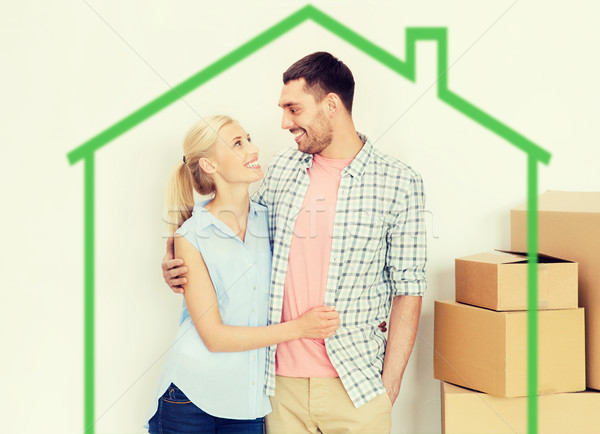 couple with cardboard boxes moving to new home Stock photo © dolgachov