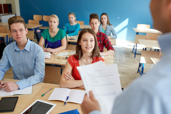 group of students and teacher with papers or tests Stock photo © dolgachov