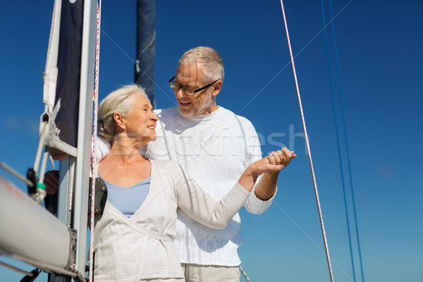 happy senior couple on sail boat or yacht in sea Stock photo © dolgachov