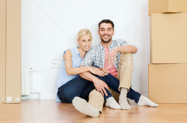 couple with cardboard boxes moving to new home Stock photo © dolgachov