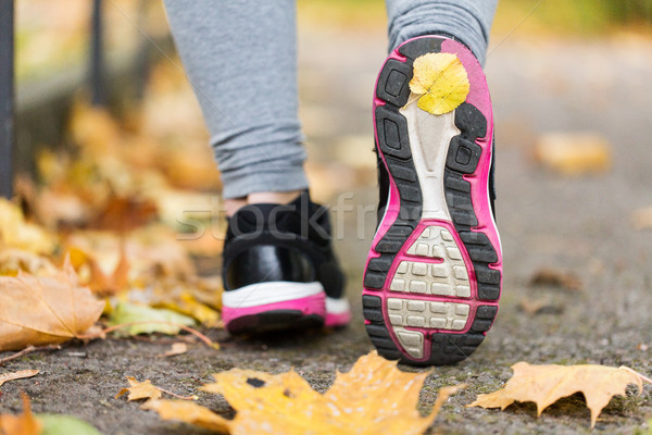 close up of woman feet wearing sneakers in autumn Stock photo © dolgachov