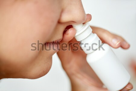 close up of sick woman using nasal spray Stock photo © dolgachov