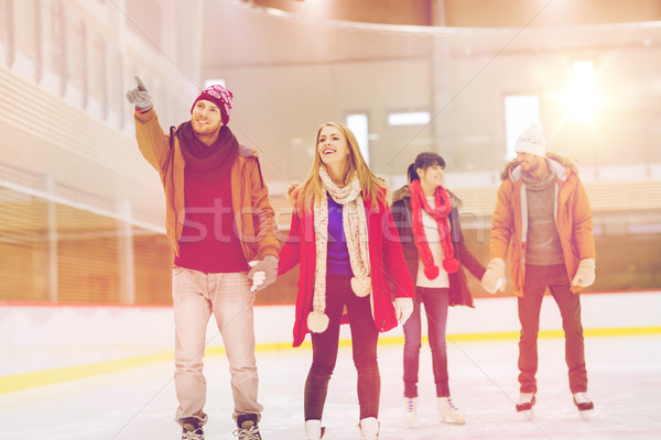 Boldog barátok mutat ujj korcsolyázás pálya Stock fotó © dolgachov