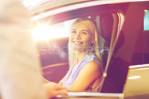 happy woman with car dealer in auto show or salon Stock photo © dolgachov