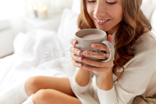 Stock photo: close up of happy woman with cocoa cup at home