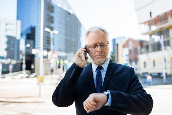 senior businessman calling on smartphone in city Stock photo © dolgachov