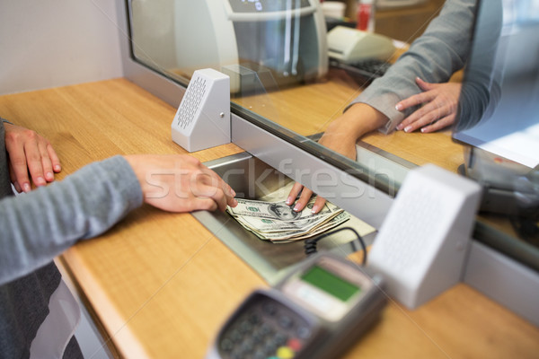 clerk giving cash money to customer at bank office Stock photo © dolgachov