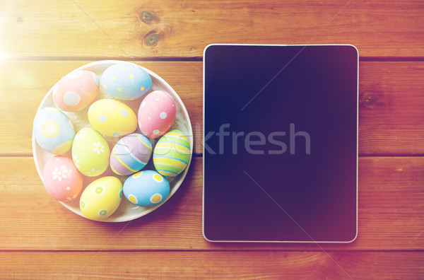 close up of easter eggs and blank tablet pc Stock photo © dolgachov