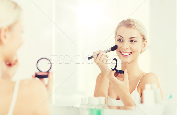 woman with makeup brush and blush at bathroom Stock photo © dolgachov