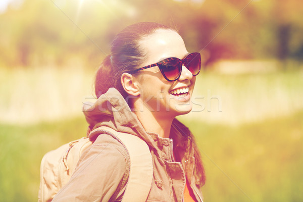 happy young woman with backpack hiking outdoors Stock photo © dolgachov