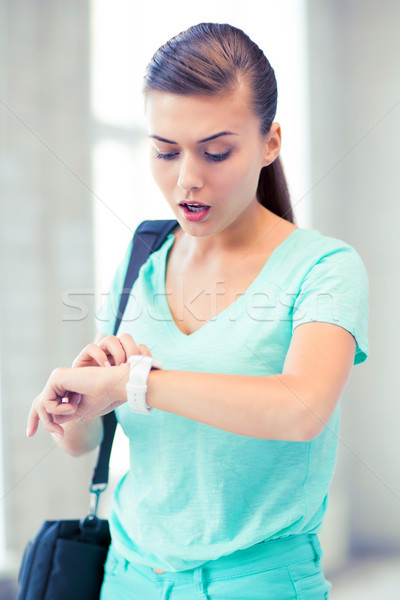 surprised student girl looking at clock Stock photo © dolgachov
