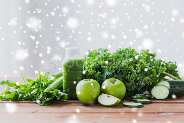 Stock photo: close up of bottle with green juice and vegetables
