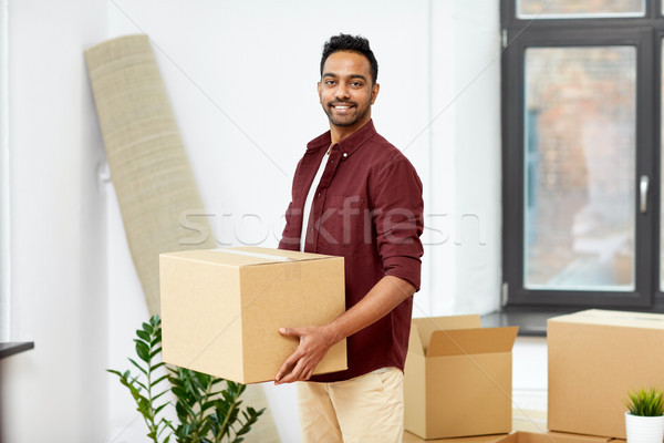 happy man with box moving to new home Stock photo © dolgachov