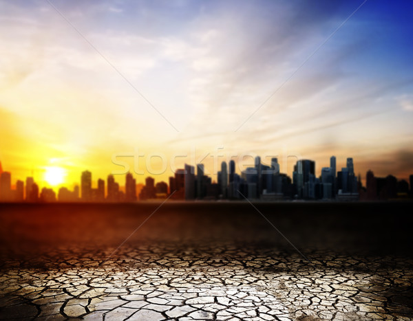 cracked desert surface over sunset in city Stock photo © dolgachov