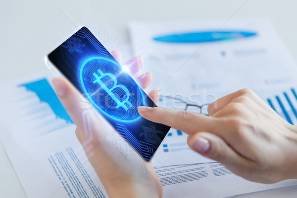 close up of hand with bitcoin on smartphone screen Stock photo © dolgachov