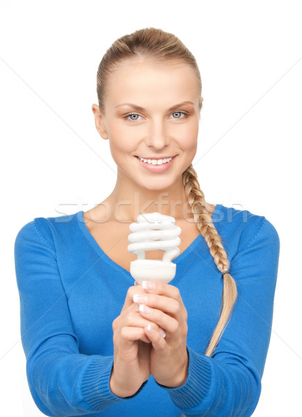 Stock photo: woman holding energy saving bulb