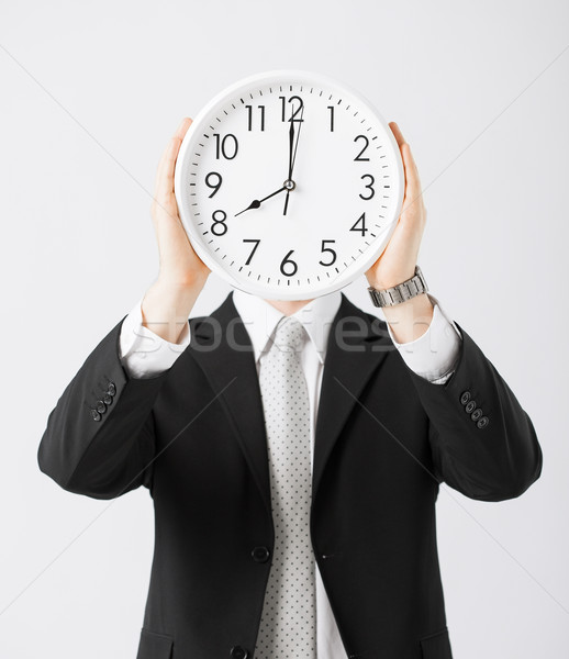 man with wall clock Stock photo © dolgachov