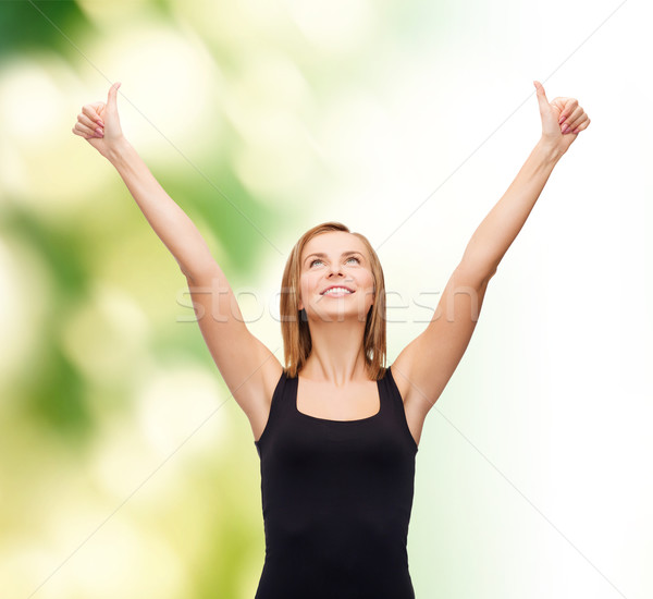 woman in blank black tank top showing thumbs up Stock photo © dolgachov