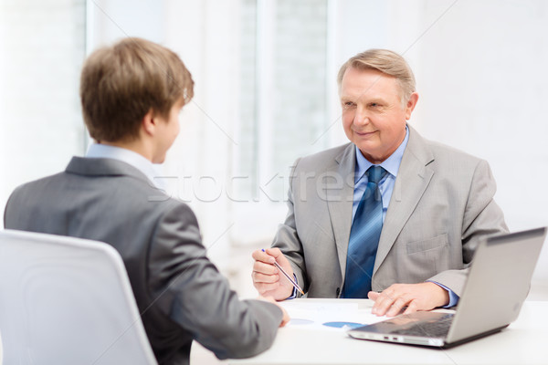older man and young man having meeting in office Stock photo © dolgachov