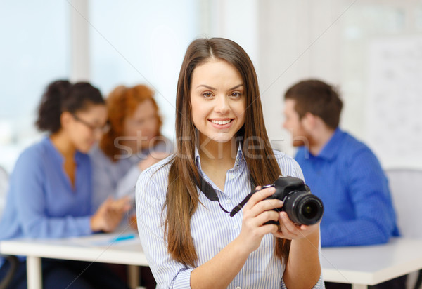 Stock photo: smiling female photographer with photocamera