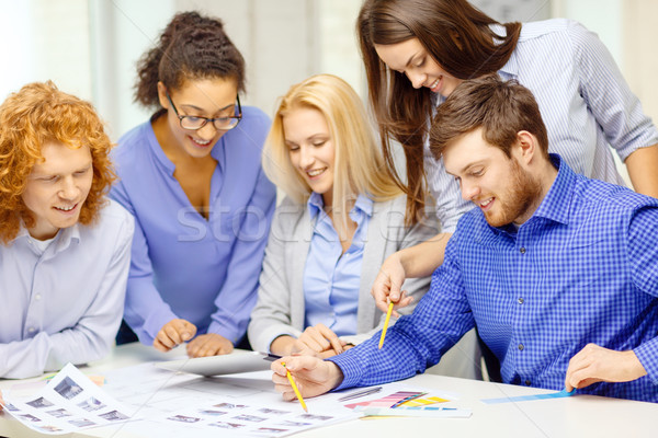 Stock photo: smiling team with color samples at office