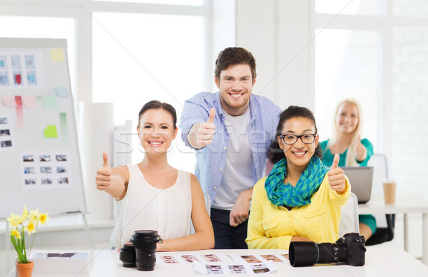 smiling team with photocamera in office Stock photo © dolgachov