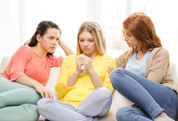 two teenage girls comforting another after breakup Stock photo © dolgachov