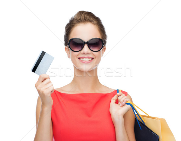 smiling woman with shopping bags and plastic card Stock photo © dolgachov