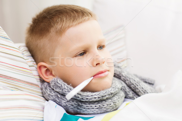 ill boy with flu at home Stock photo © dolgachov