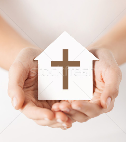 hands holding paper house with cross symbol Stock photo © dolgachov