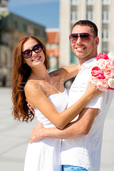smiling couple in city Stock photo © dolgachov