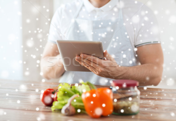 closeup of man reading recipe from tablet pc Stock photo © dolgachov