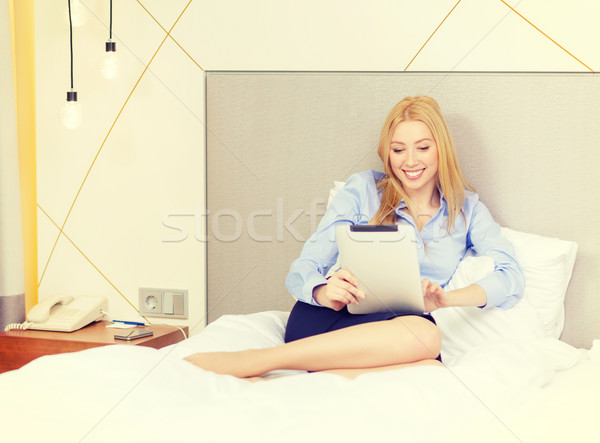 happy businesswoman with tablet pc in hotel room Stock photo © dolgachov