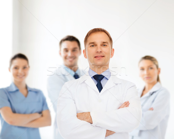 smiling male doctor in white coat Stock photo © dolgachov