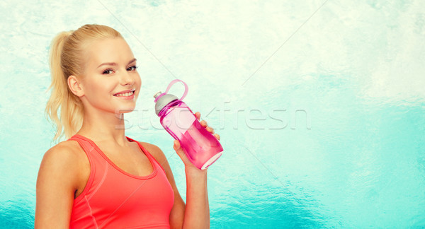 Souriant femme une bouteille d'eau sport exercice [[stock_photo]] © dolgachov