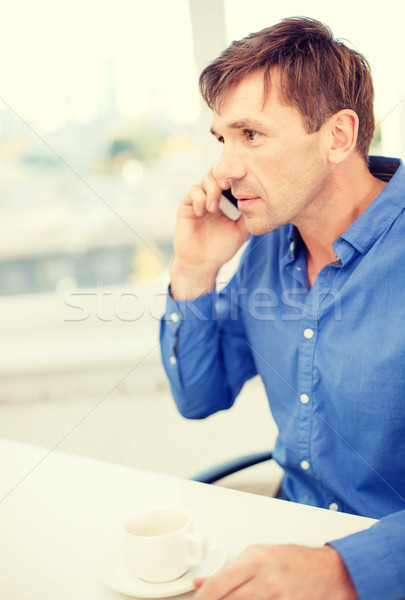 businessman with cell phone and cup of coffee Stock photo © dolgachov