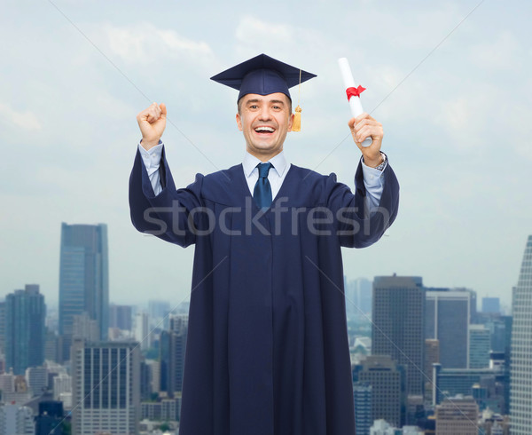 smiling adult student in mortarboard with diploma Stock photo © dolgachov