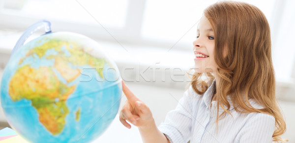 smiling student girl with globe at school Stock photo © dolgachov