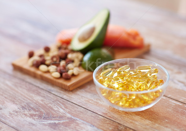 close up of omega 3 capsules and food on table Stock photo © dolgachov