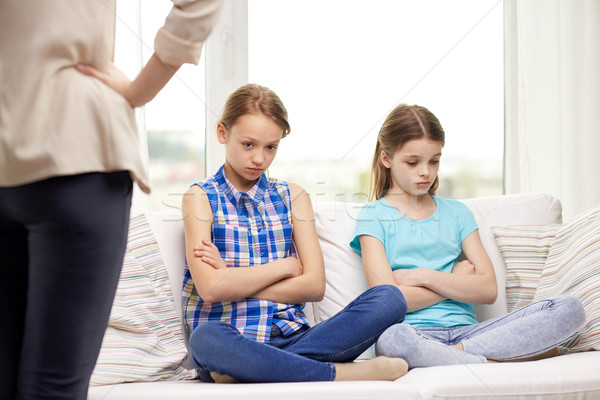 upset guilty little girls sitting on sofa at home Stock photo © dolgachov