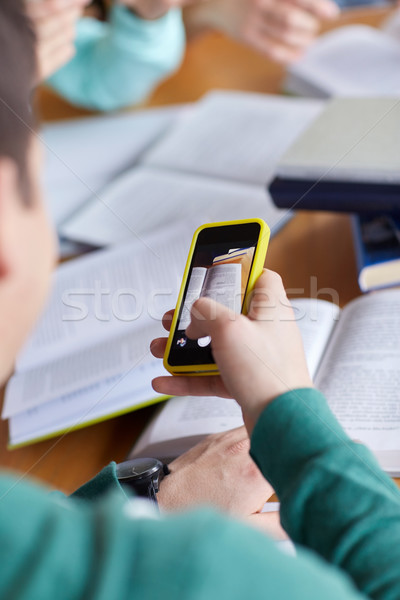 student hands with smartphone making cheat sheet Stock photo © dolgachov