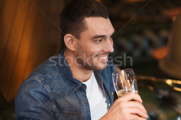 Stock photo: happy man drinking beer at bar or pub