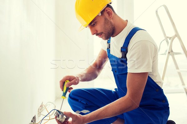builder with tablet pc and equipment indoors Stock photo © dolgachov