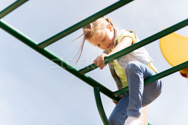 happy little girl climbing on children playground Stock photo © dolgachov