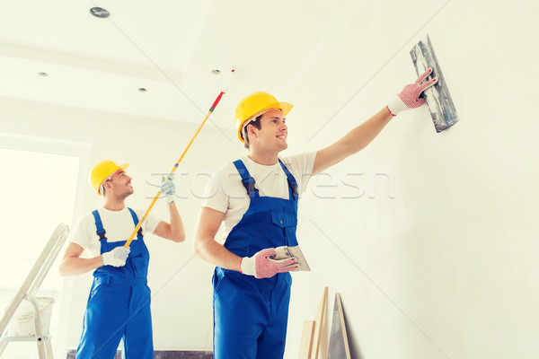 group of builders with tools indoors Stock photo © dolgachov